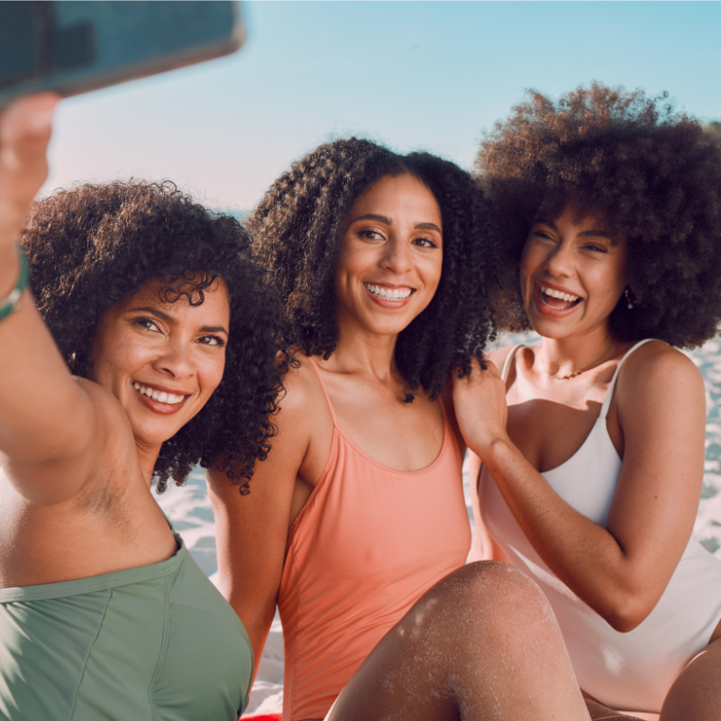 women with curly hair on the beach