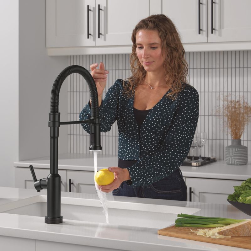 mother rinsing fruit with touch faucet