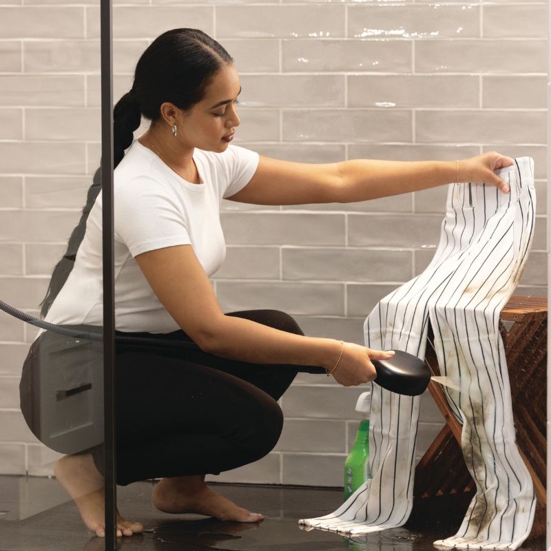 woman using proclean spray in the shower
