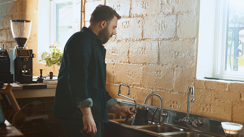 A person standing in a kitchen