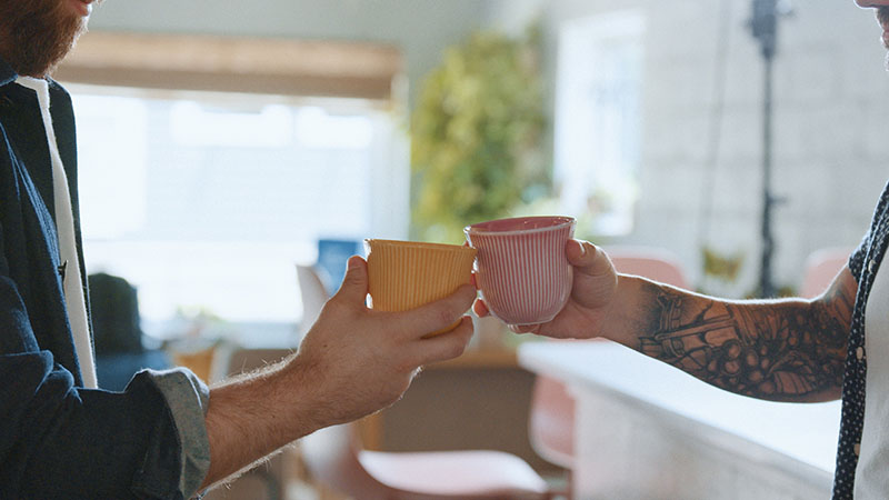 people holding coffee cups