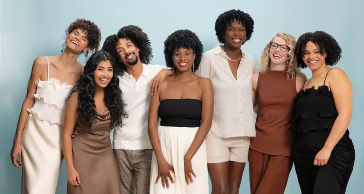 Group of people smiling with curly hair