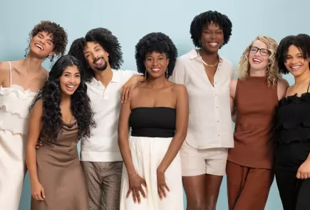 Group of people smiling with curly hair